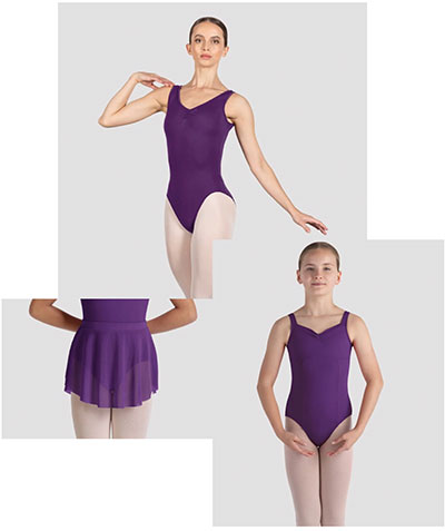 Three female ballet dancers wearing aubergine colored leotards